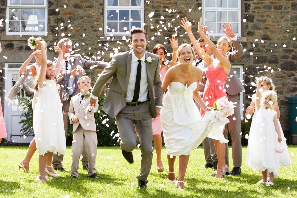 Wedding guests throwing confetti