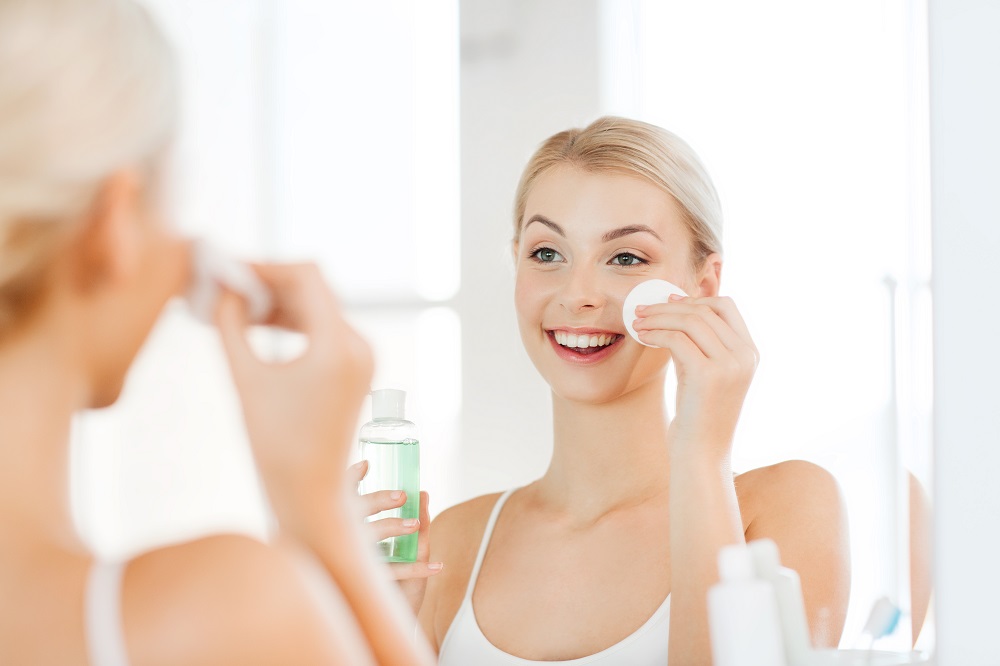 Woman applying facial toner