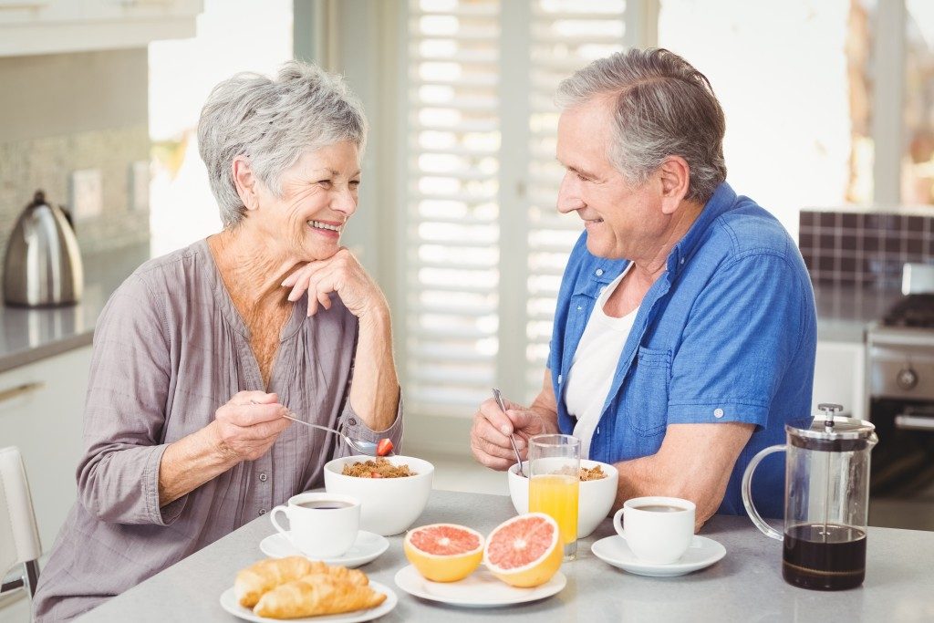 Senior couple eating breakfast
