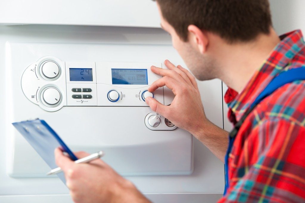 man checking home heating system