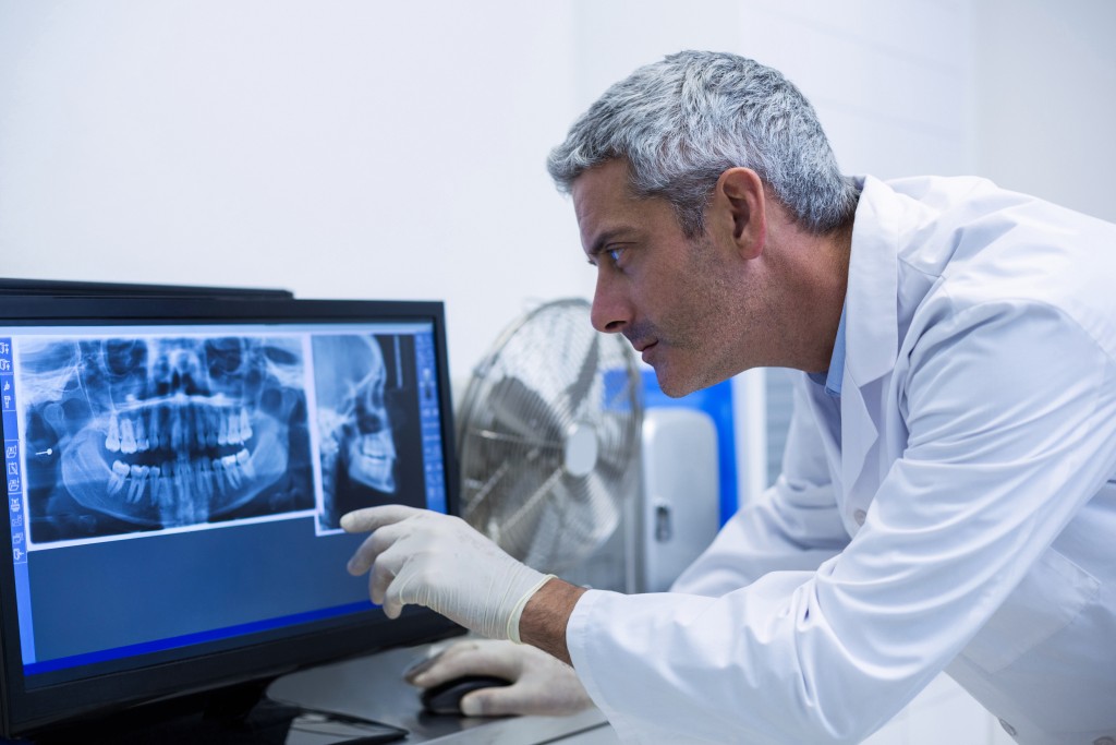 dentist examining an x-ray on the monitor in clinic