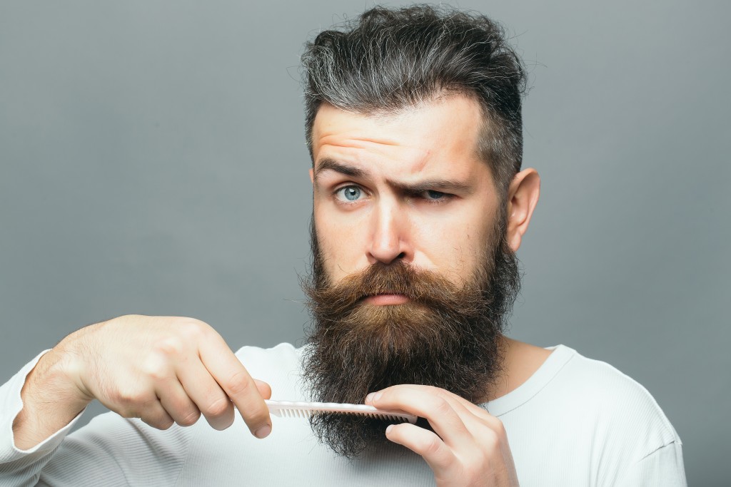 man trimming beard