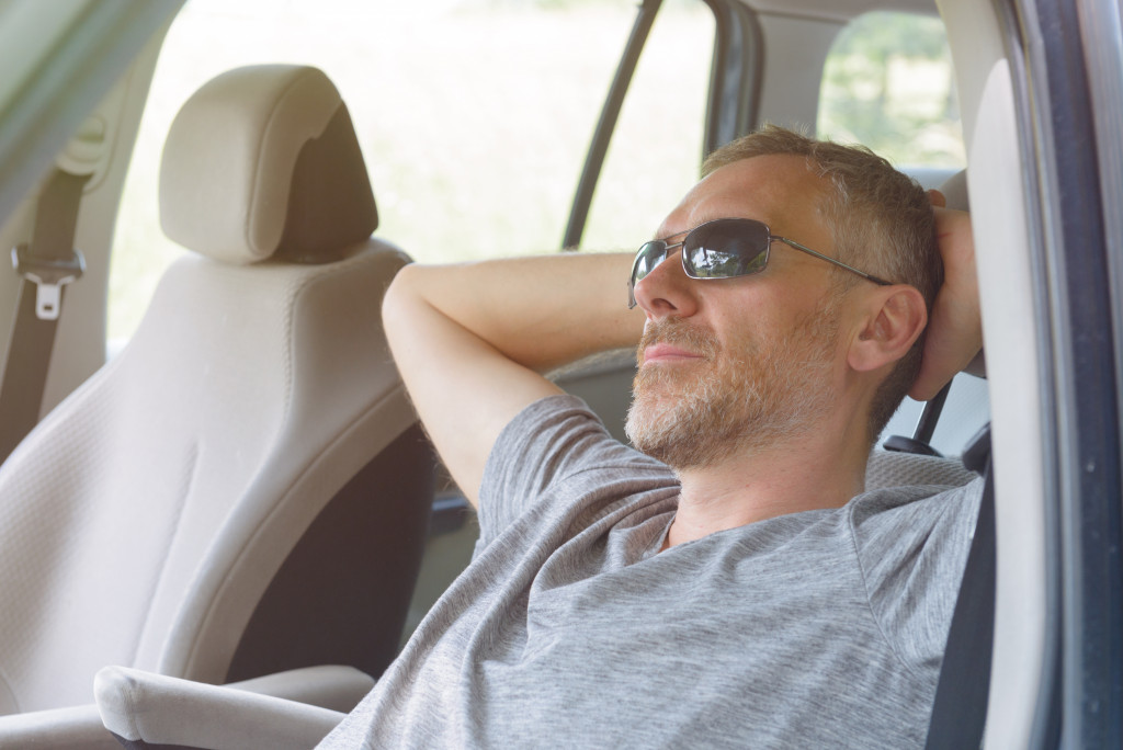 man relaxing in car