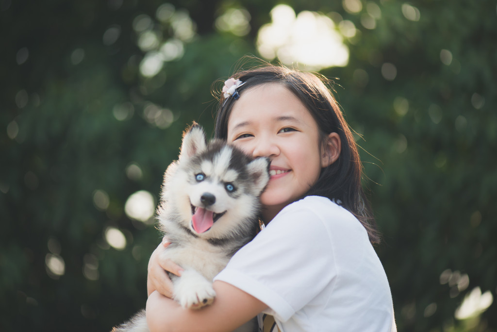 girl holding a puppy