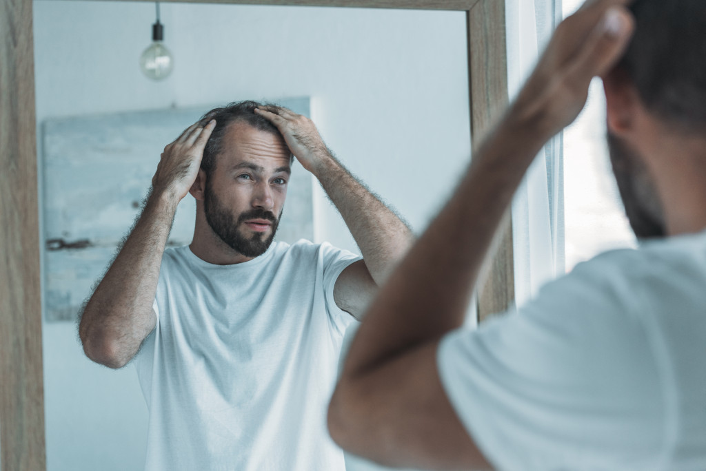 man touching hair