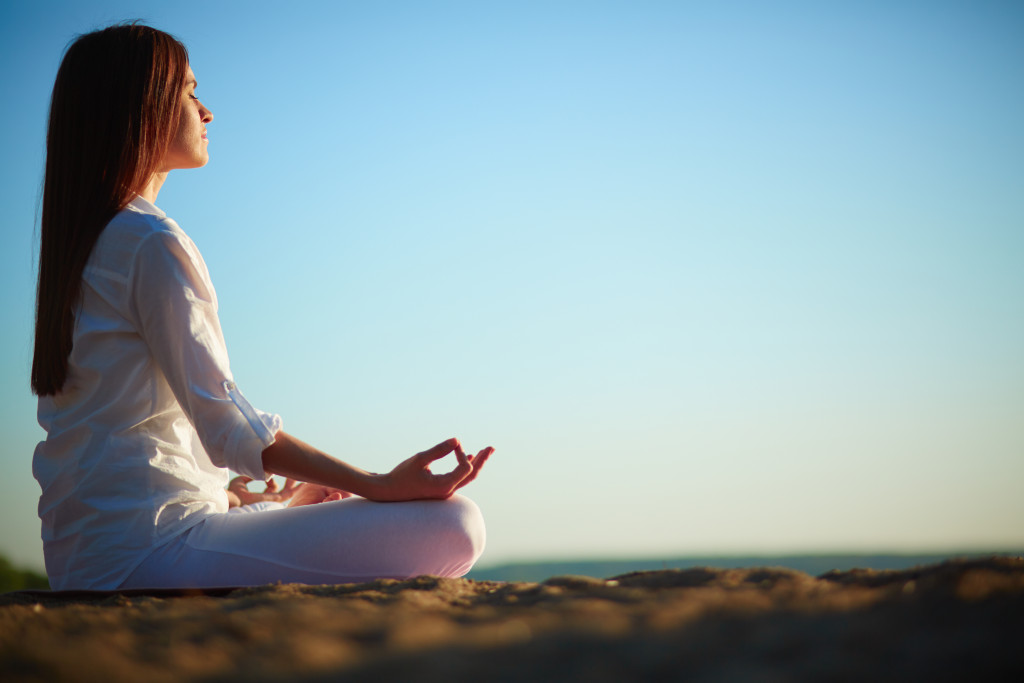 Woman meditating outdoors