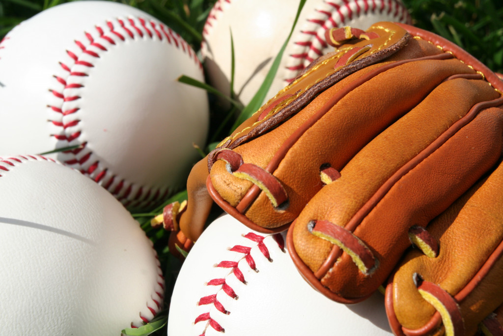 Baseball and glove on ground