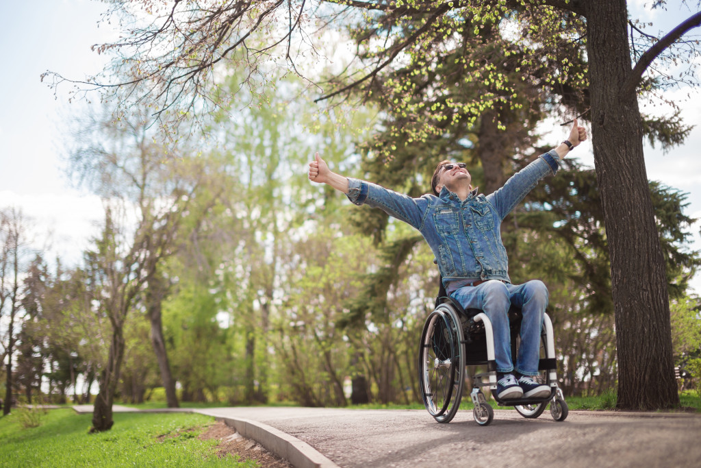 young man in the park riding his wheelchair