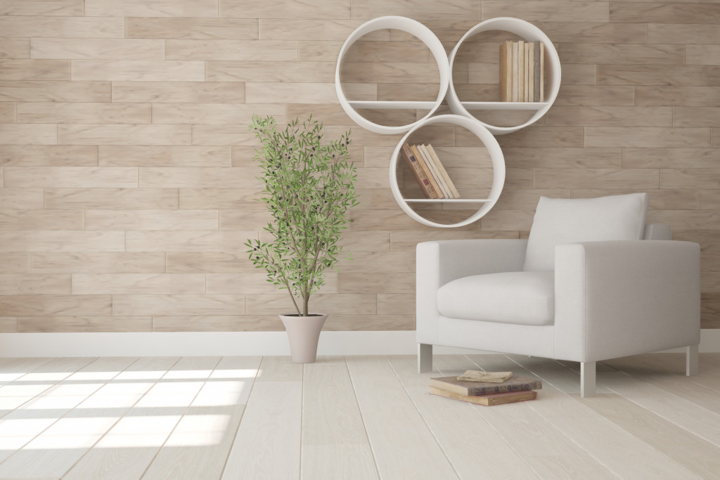 a neutral-colored accent wall with a sofa and plant