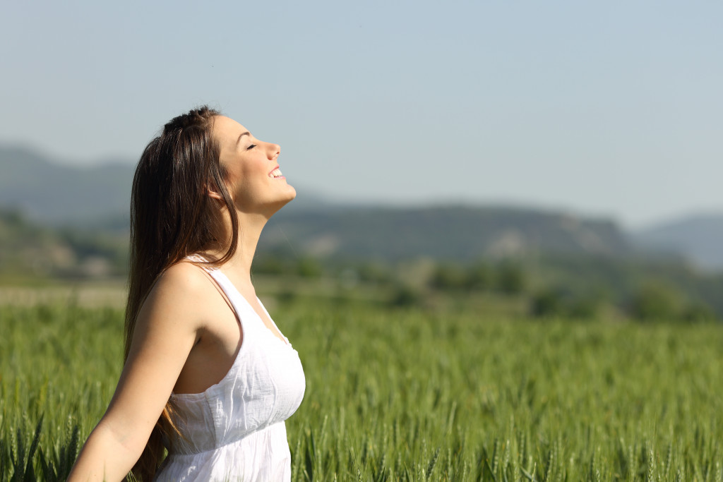 Woman enjoying the fresh air in the fields