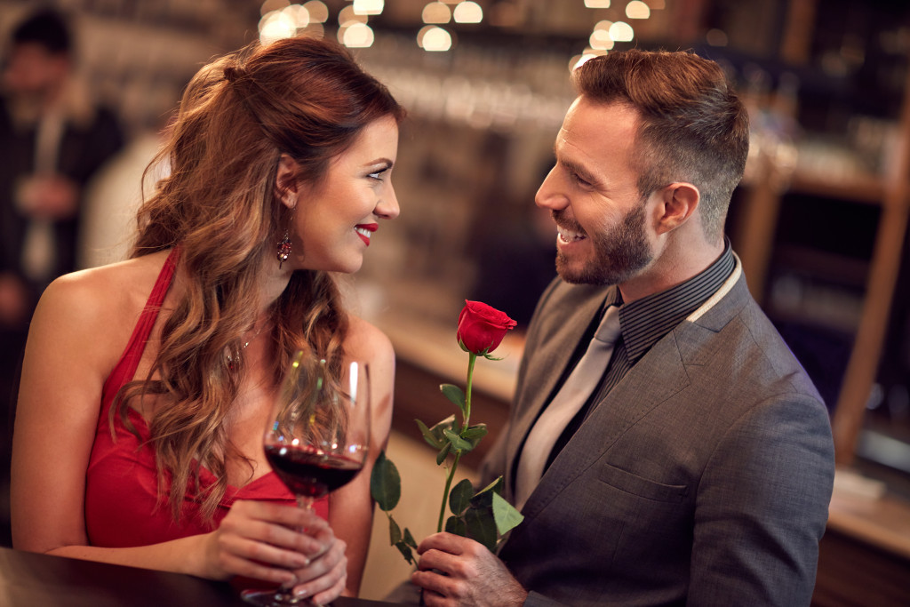 man giving a rose to his date
